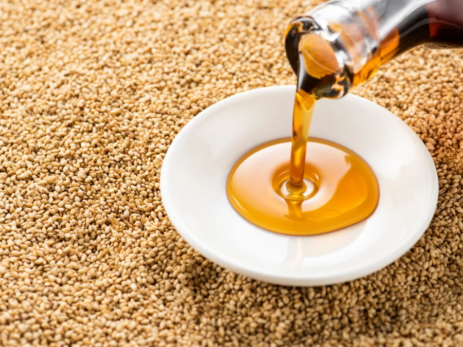 alt="Pouring sesame oil into a small white dipping dish"
