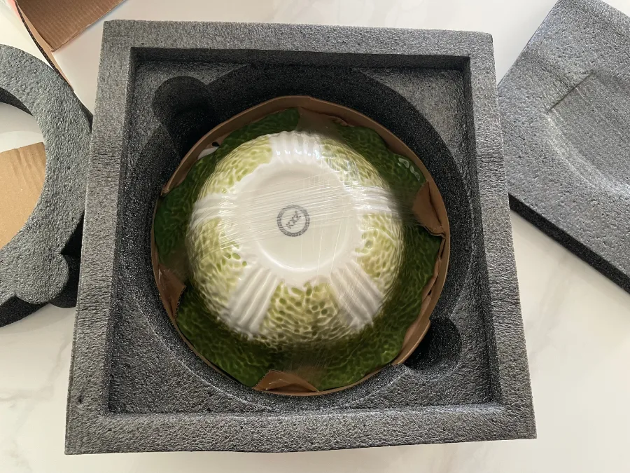 alt="Opened box revealing the cabbage-shaped bowl set"