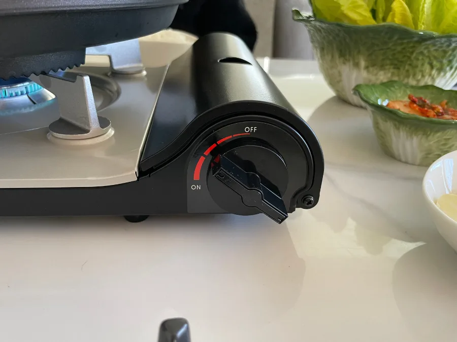 alt="Techef gas stove lever set to medium heat while preheating for Korean BBQ"