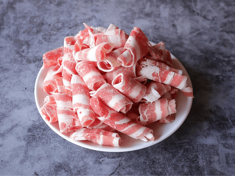 alt="Thinly sliced Korean BBQ meat ready for grilling"  
