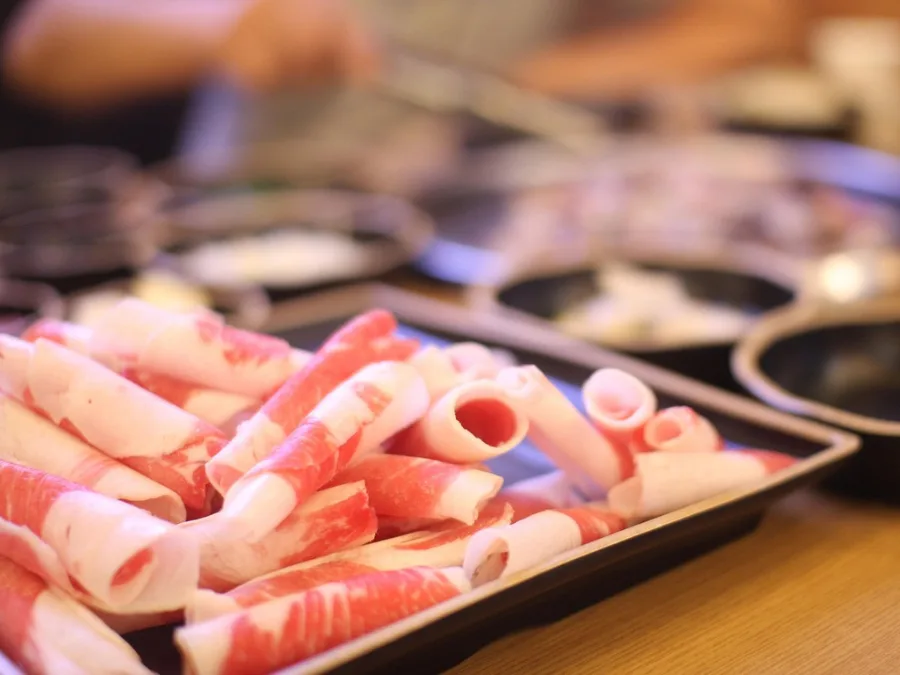 alt="Thinly sliced beef brisket (chadolbagi) served on a plate before grilling"
