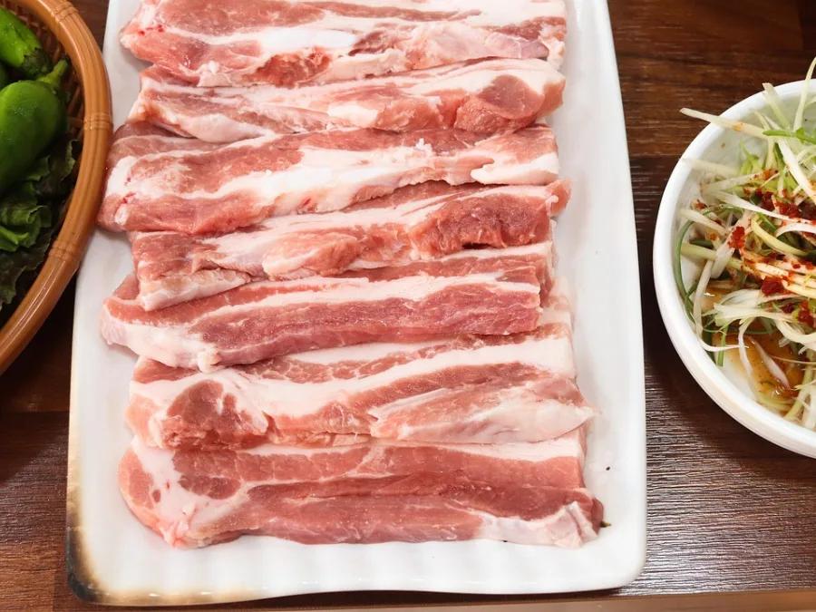 alt="Pork belly on a plate before grilling for Korean BBQ"
