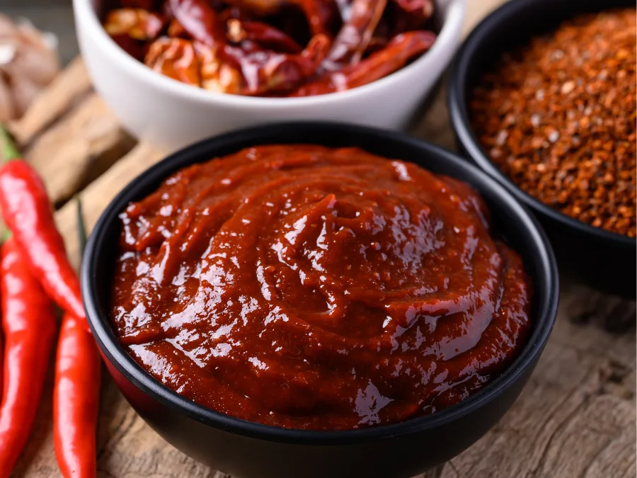 alt="A large bowl filled with Korean gochujang red chili paste"