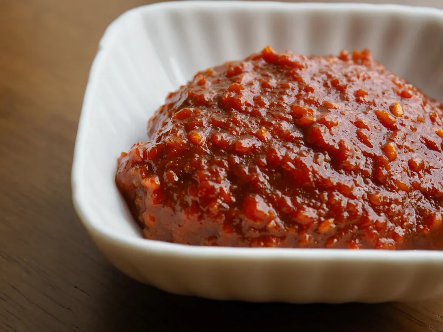 alt="Close-up of ssamjang Korean dipping sauce in a square dish"