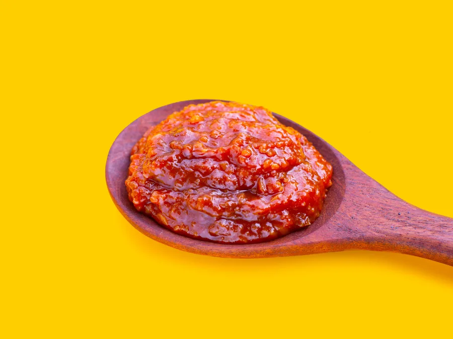alt="Ssamjang Korean dipping sauce on a wooden spoon"